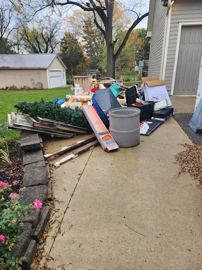 Dumpster being loaded with debris for Estate Cleanout Dumpster Rental in Lyman